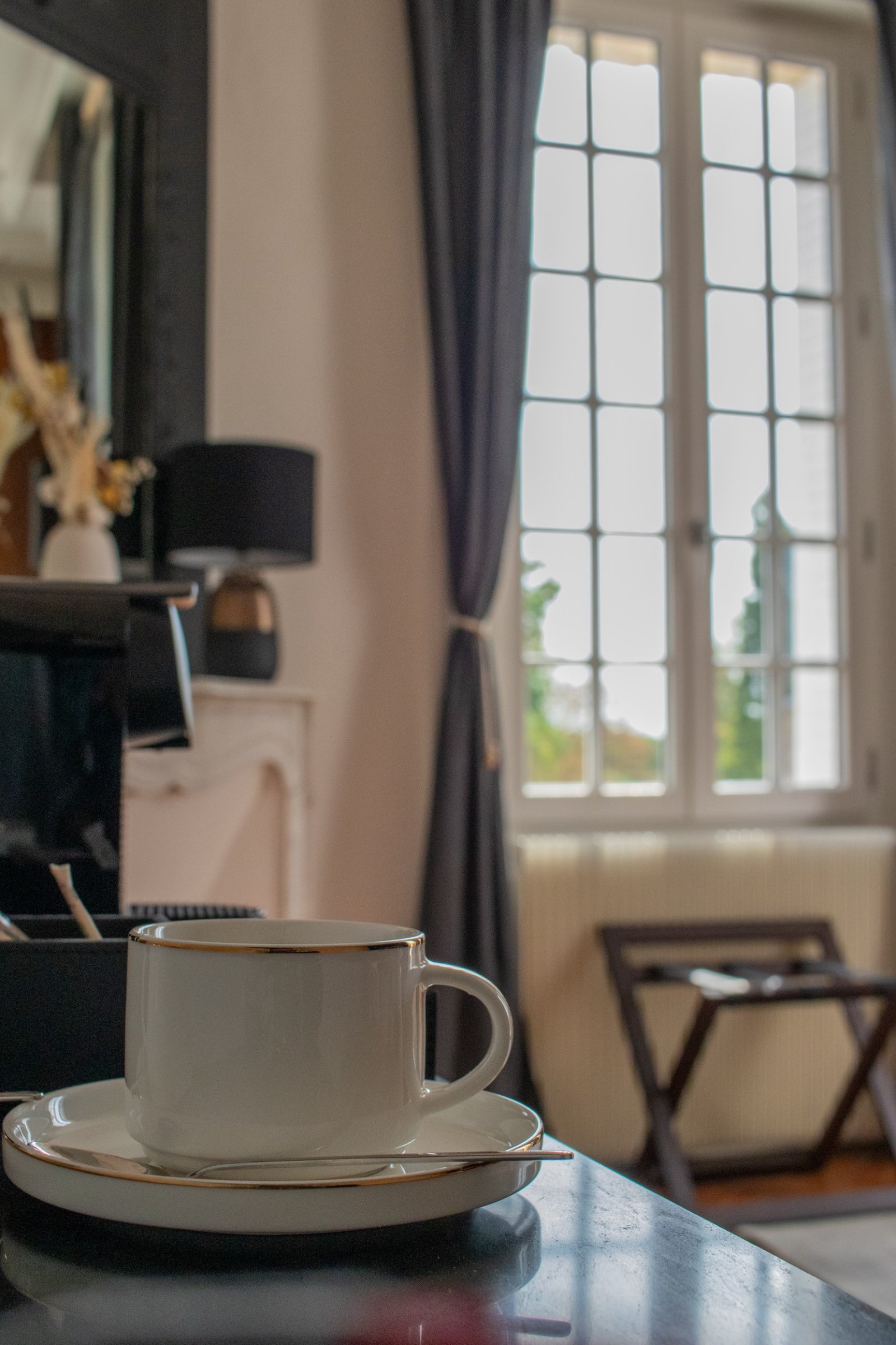 Coffee cup in a softly lit guest room